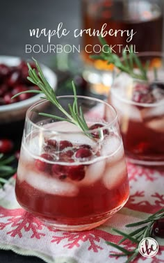 two glasses filled with cranberry bourbon cocktail on top of a red and white table cloth