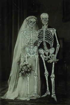 an old black and white photo of a couple dressed up in skeleton costumes for their wedding