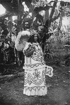 an old photo of a woman dressed in native clothing