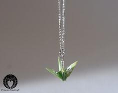 Delicate handmade origami crane pendant. :)   The cranes are lacquered many times and will withstand rain to a certain degree.  Although this is made of paper, it's fairly solid. Chain is 45 cm (17"). Origami Crane, Pastel Green, Origami, Favorite Jewelry, Necklace Lengths, Wedding Gifts, Jewelry Necklace Pendant, Beauty Book, Jewelry Necklaces