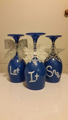 three blue vases with silver bows and let it snow written on the front one