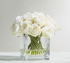 a vase filled with white flowers on top of a table