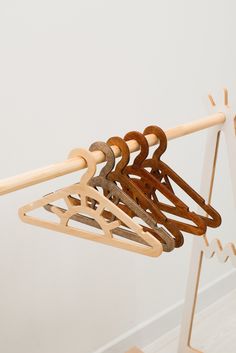 several wooden clothes hangers on a white wall