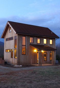 Exterior view of cabin from front Cabin With Porch, Natural Wood Siding, Front Door Modern, Black Metal Roof