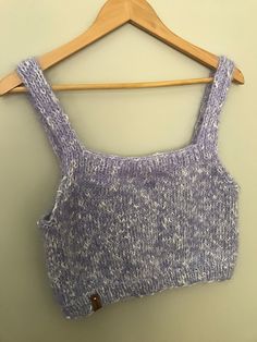 a sweater hanging on a wooden hanger