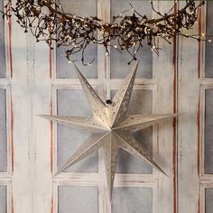 a large metal star hanging from the ceiling