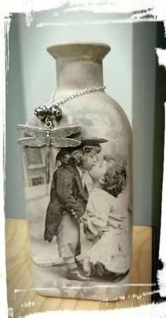 a glass vase with a dragonfly on it