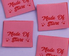 four pink made of stars patches on a purple background with red writing that says made of stars