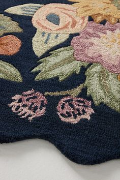 a blue rug with flowers and leaves on it