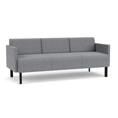 a gray couch sitting on top of a white floor