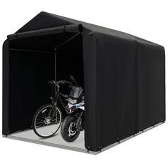 a motorcycle is parked in the back of a storage shed with its door open to show it's bike