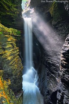 a waterfall with water cascading down it's sides