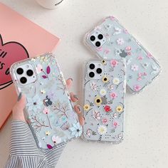 three clear cases with flowers on them