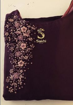 the back of a purple shirt with flowers on it