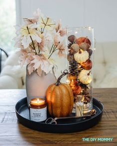 a tray with flowers and candles on it