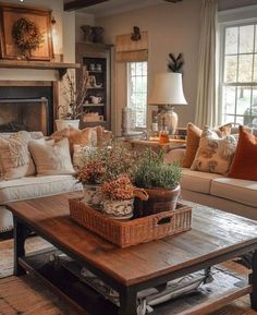 a living room filled with furniture and a fire place under a window next to a fireplace