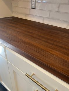 a counter top in a kitchen with white cabinets