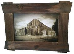 an old wooden frame with a barn painting on it's side and a white sky in the background