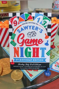 a game night birthday party with popcorn, cards and coins on a table in front of them