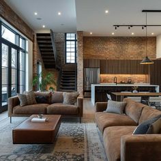 a living room filled with furniture next to a kitchen