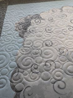 a close up of a sheep's head on a quilted tablecloth with circles