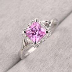 ◆ The ring is handcrafted from sterling silver and decorated with a dazzling 6*6 mm pink sapphire and CZs. It is suitable for engagement/anniversary/daily occasion. ◆ Production Description: Main stone Type: Lab Pink Sapphire Main Stone Shape: Princess Cut Main Stone Size: 6*6 mm(1.37ct) Side stone: CZ Metal: 925 Sterling silver - Other options available in the drop down menu ◆ Customization: √Free for Add Engraving √Other Metal Type Available √Other Gemstones & Shapes Available √Personalization Dazzling Pink Sterling Silver Ring, Pink Sapphire Ring With Halo Setting For Formal Occasions, Classic Pink Ruby Ring With Halo Setting, Pink Diamond Ring With Halo Setting For Formal Occasions, Pink Diamond Ring With Halo Setting For Formal Events, Formal Pink Sterling Silver Diamond Ring, Elegant Pink Amethyst Ring With Halo Setting, Pink Sterling Silver Crystal Ring With Center Stone, Pink Sterling Silver Crystal Ring With Gem