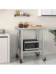 a microwave sitting on top of a metal cart