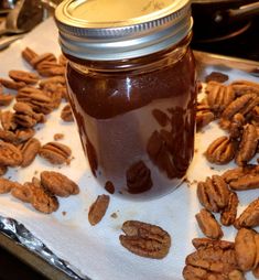 a jar filled with pecans sitting on top of a table