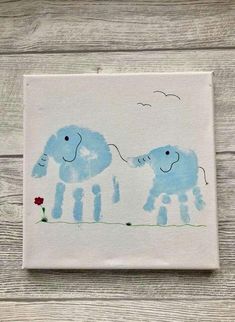 two blue elephants painted on white paper with flowers in the foreground and birds flying overhead