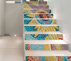 the stairs are decorated with colorful mosaic tiles and have an artistic design on each handrail