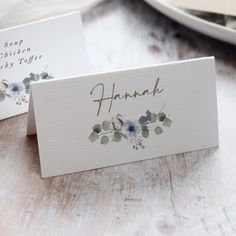 two place cards sitting on top of a table