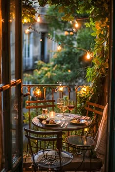 an outdoor dining area is lit up with string lights and hanging lanterns above the table