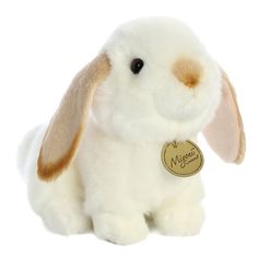 a white stuffed rabbit with brown ears