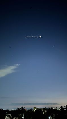 the night sky is lit up with stars and moon in the distance, as well as some clouds