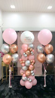 balloons and streamers are on display in front of a birthday sign