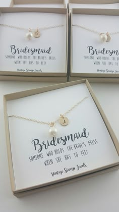 three personalized bridesmaid necklaces in boxes