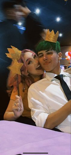 a man and woman dressed in costume posing for a photo with a star on their forehead