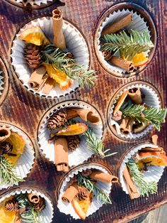 small cupcakes with cinnamon sticks and pine cones on them are arranged in muffin tins