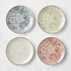 four plates sitting on top of a white counter