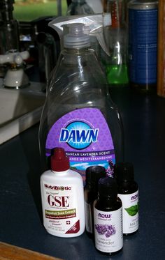 several bottles of liquid sitting on top of a counter