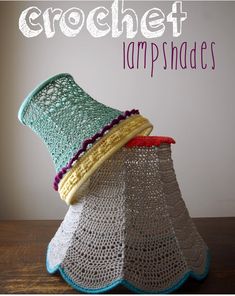 two crochet lampshades sitting on top of a wooden table