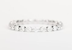 a white gold ring with five round diamonds