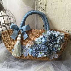 a woven bag with flowers and tassels on it