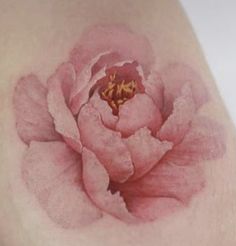 a woman's breast with a pink flower on it