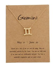 a gold zodiac sign necklace on a card with the words gemini written in it