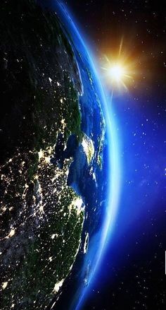 the earth is lit up at night with bright lights on it's side and in the foreground