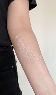 a person with a white tattoo on their arm