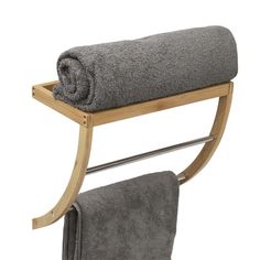 a towel rack with two towels hanging from it's sides and a towel on top