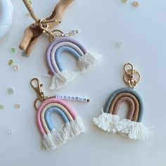 three key chains with tassels on them