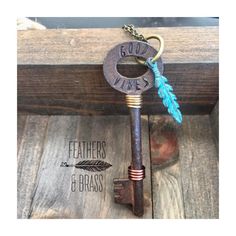 the key to god's wars is attached to an antique key with a feather on it